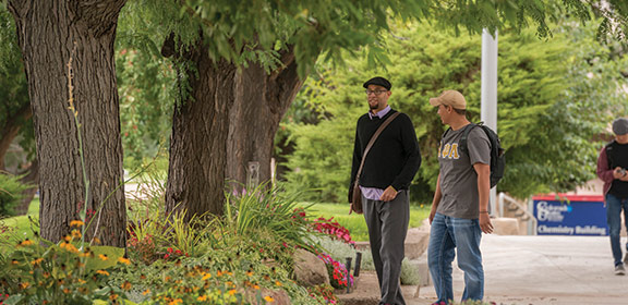 Colorado State University-Pueblo student walking with faculty member