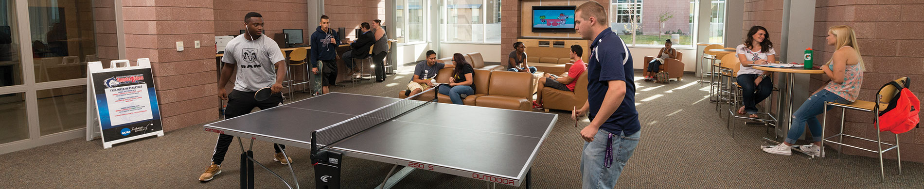 Students playing ping pong in the Culebra Lobby