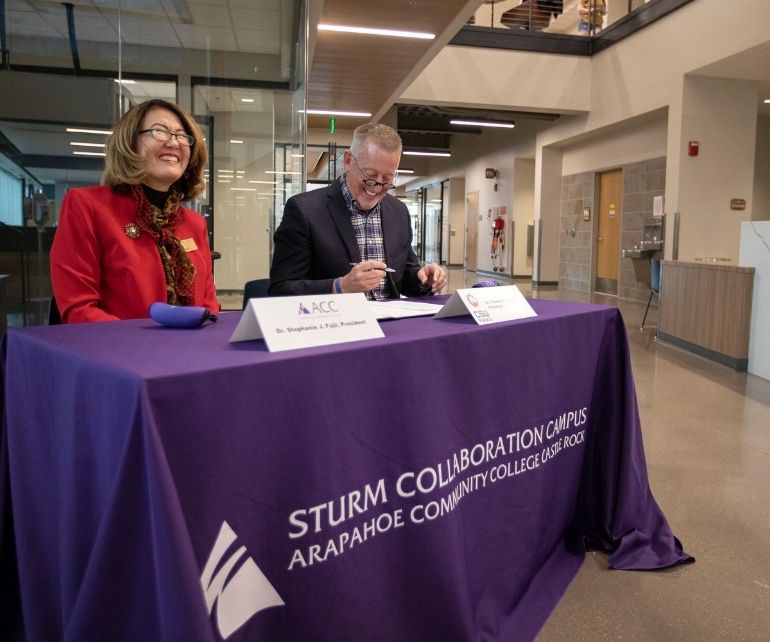 Dr. Stephanie Fujii and and Dr. Timothy Mottet sign an articulation agreement at the ACC Sturm Collaboration Campus at Castle Rock