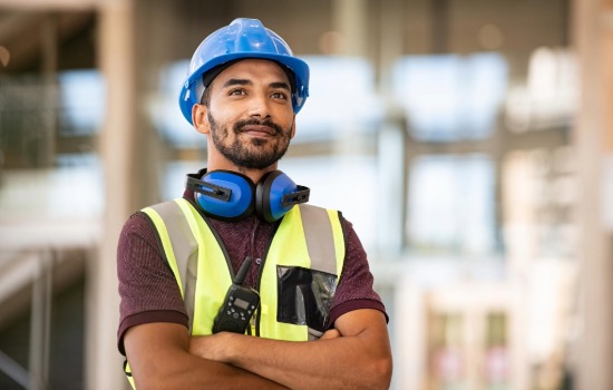 man standing in a hard hat smiling