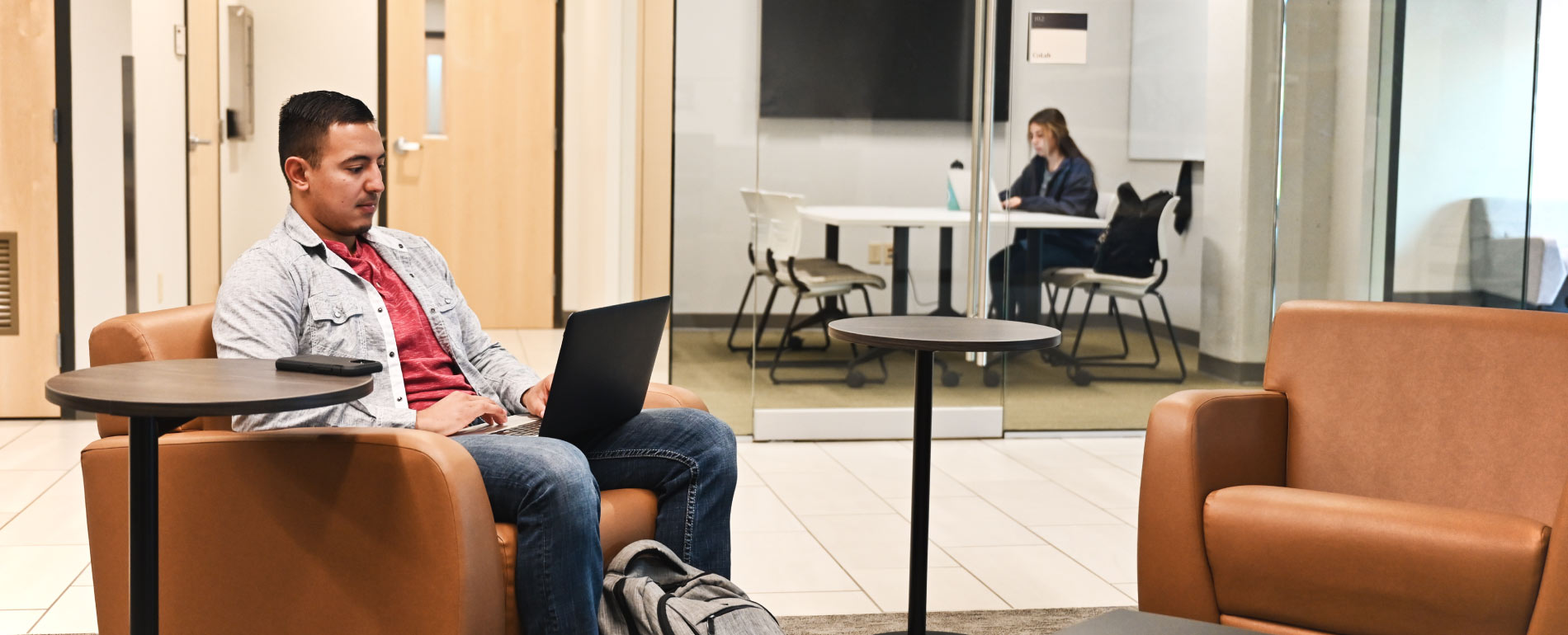 Student sitting in IHHI lounge