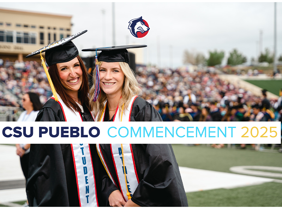 two students smiling during commencement ceremony