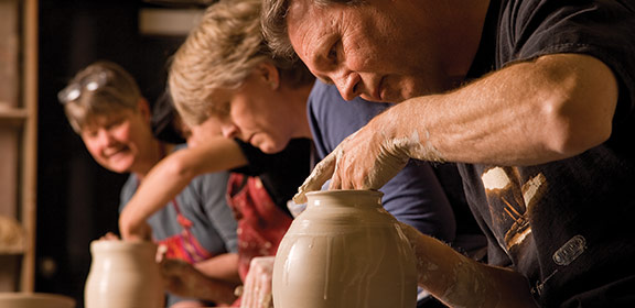 A group of individuals working on pottery.