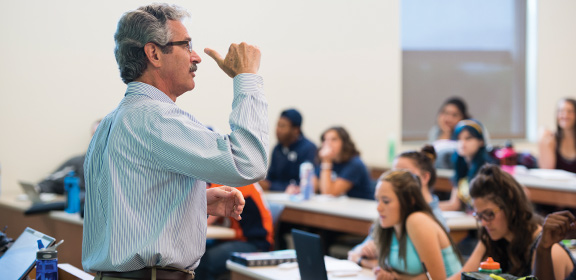 Professor Samuel Ebersole teaching media and society in the General Classroom Building