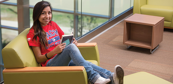 A Colorado State University-Pueblo student reading a book in the General Classroom Building