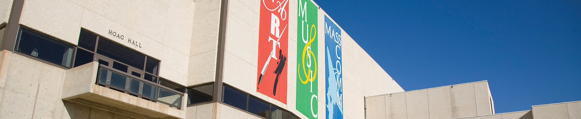 The Art and Music building displaying banners of CHASS