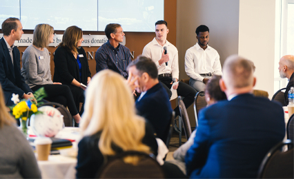 Group photo of students presenting to leadership.