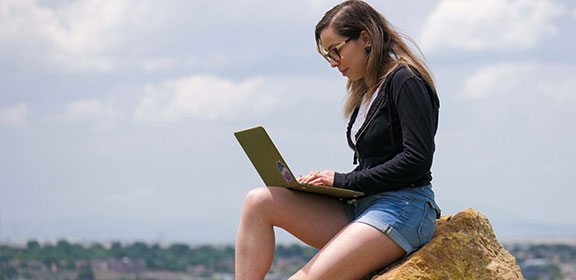Student taking a call on her laptop