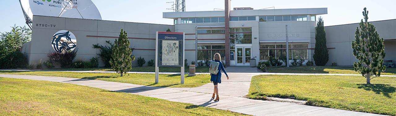 person walking in front of visitor center