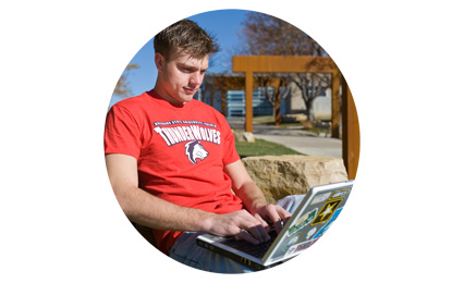 student looking at laptop