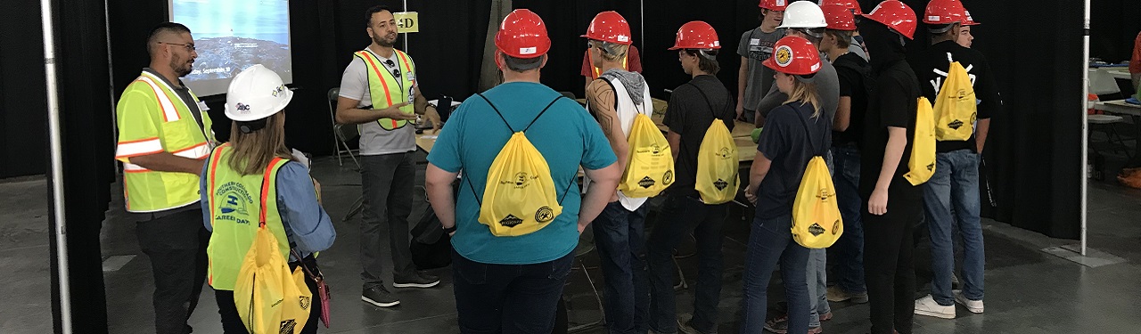 Students gathered with hard hats