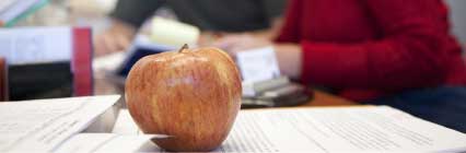 Apple with student and teacher in the background