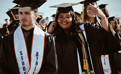 students smiling during commencement
