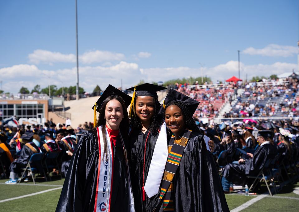 CSU Pueblo graduates posing together at commencement
