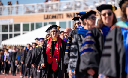 faculty in regalia waiting for commencement ceremony to begin