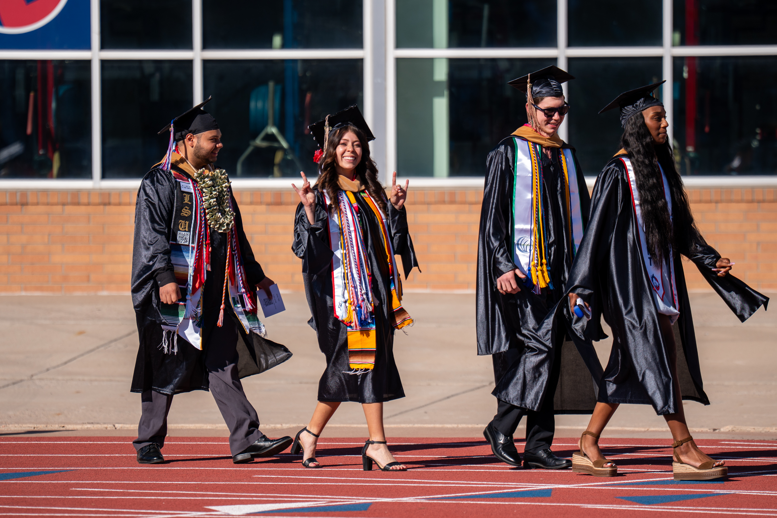 Graduates walking across the CSU Pueblo stage during commencement