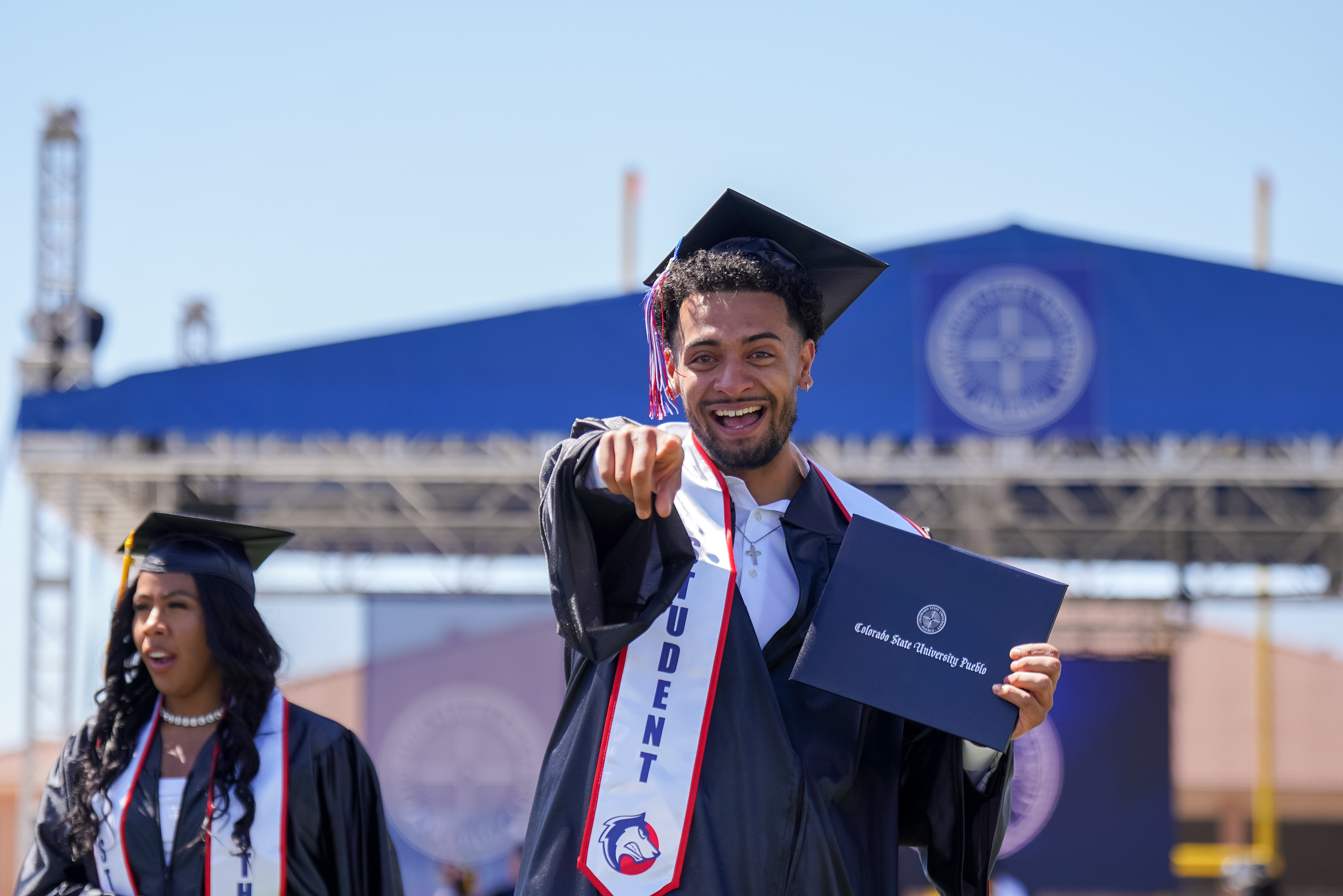Students tossing caps in the air at CSU Pueblo commencement ceremony