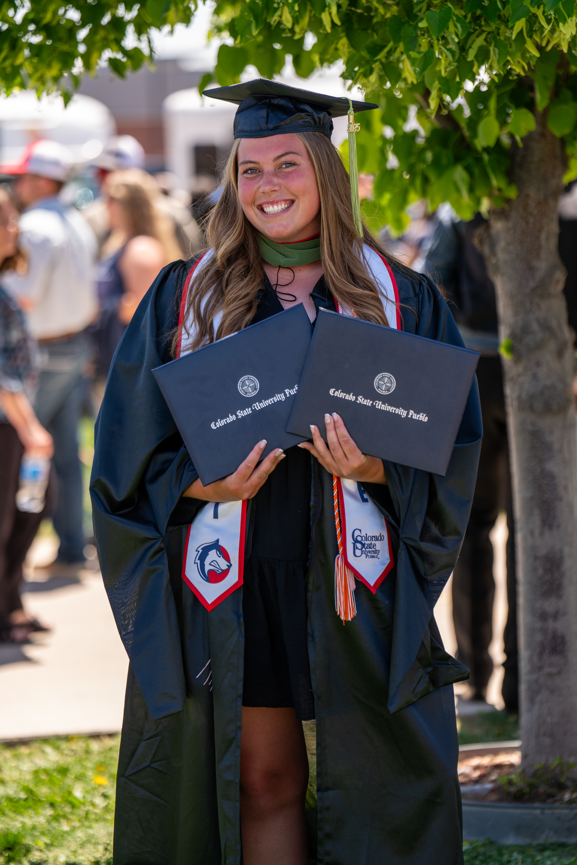 Students receiving diplomas during CSU Pueblo graduation ceremony