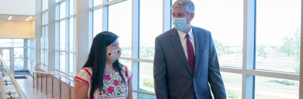 Faculty with face masks walking