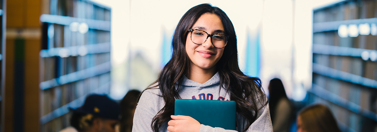 student with backpack smiling