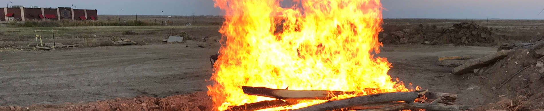 Homecoming bonfire burning at sunset