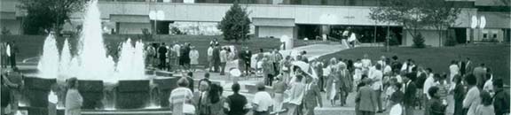 University fountain with students, library in the background