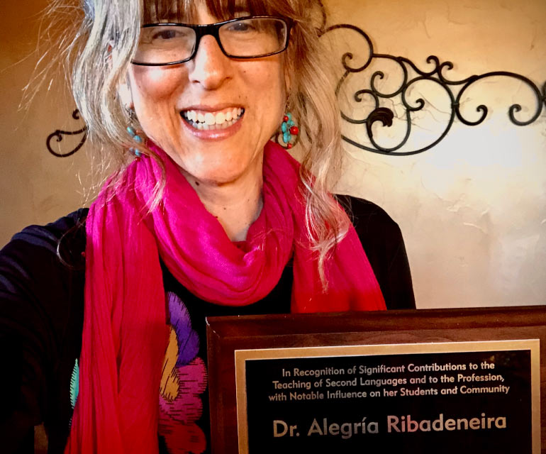 Alegria Ribadeneira posing with award plaque