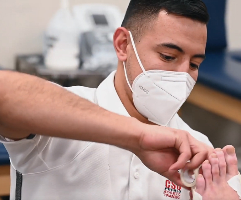 Jaime Huerta wrapping an ankle at CSU Pueblo