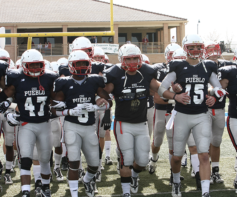 CSU Pueblo football team running to field