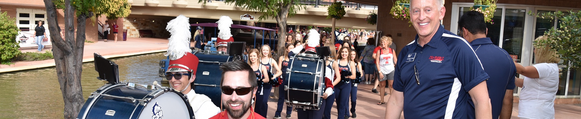 President Mottet greeting marching band during Discover Downtown