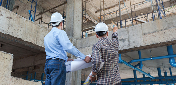 two construction people having a discussion on site