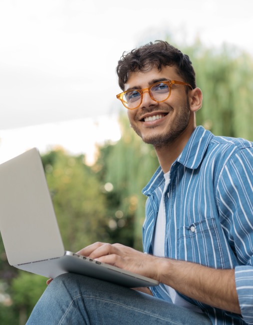 man smiling with computer