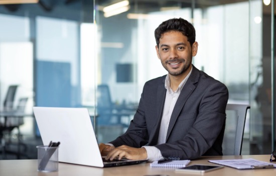 Man smiling at the computer