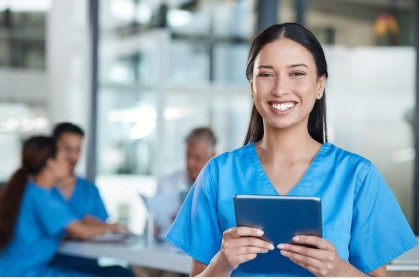 nurse holding a book smiling