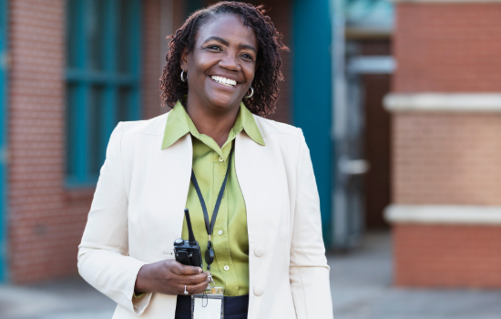 principal smiling outside school