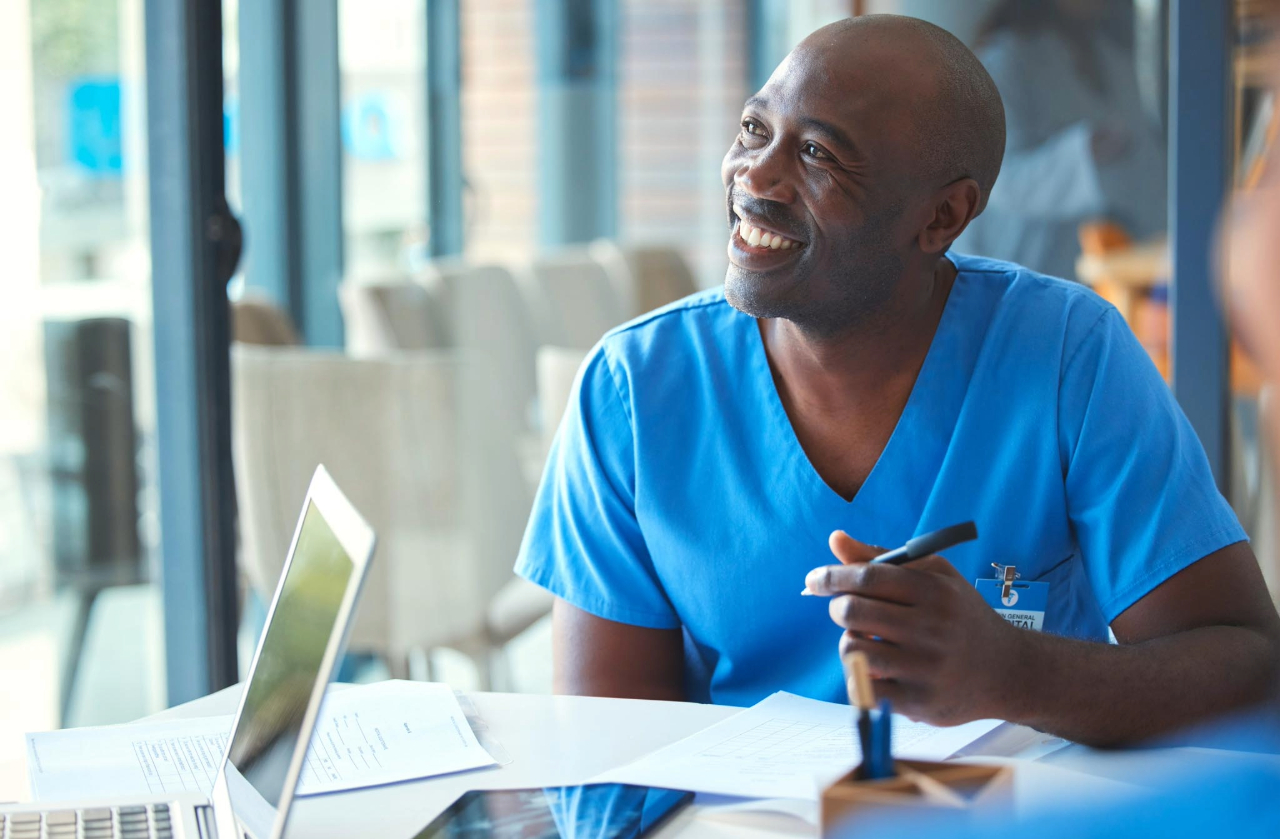 man smiling at teacher in health science clothes