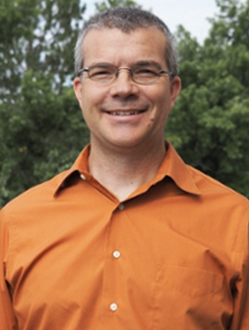 Jeff Piquette smiling in front of trees