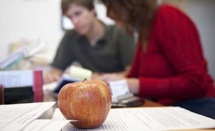 Apple with professor in the background