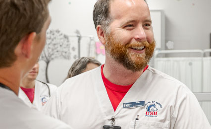 Nursing student laughing in lab