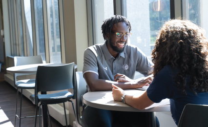 students talking in table in OSC